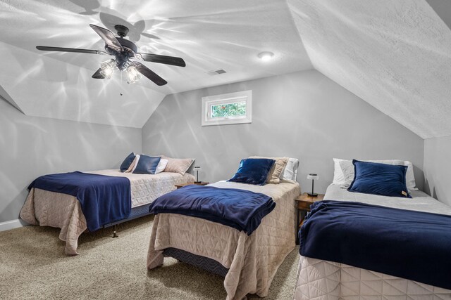 bedroom featuring ceiling fan, lofted ceiling, a textured ceiling, and carpet floors