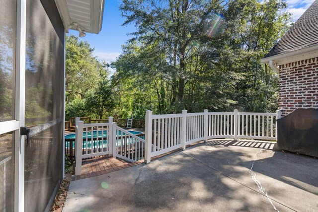 view of patio with a fenced in pool and area for grilling