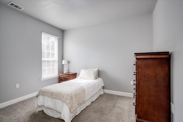 carpeted bedroom with visible vents and baseboards