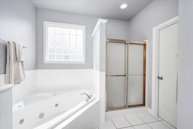 full bathroom with tile patterned floors, a tub with jets, and a stall shower