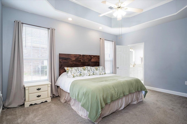 bedroom featuring baseboards, multiple windows, a raised ceiling, and carpet floors