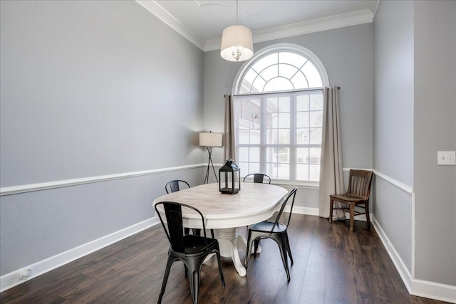 dining area featuring dark wood-style floors, baseboards, and ornamental molding