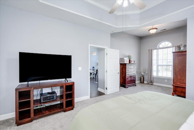 bedroom featuring a tray ceiling, carpet floors, baseboards, and ornamental molding