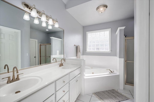 bathroom featuring tile patterned flooring, a stall shower, and a sink