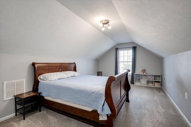 bedroom featuring visible vents, baseboards, carpet, vaulted ceiling, and a textured ceiling