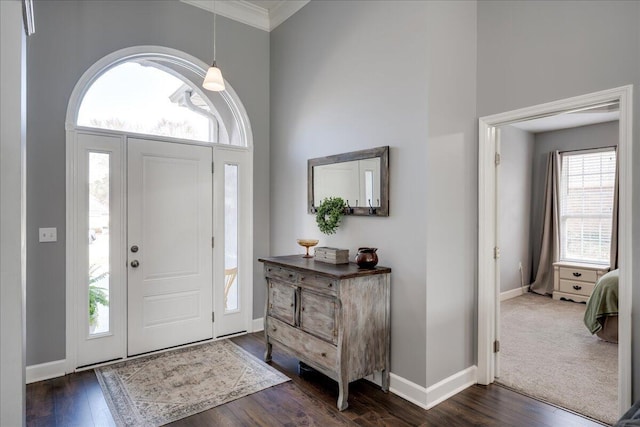 foyer featuring a high ceiling, baseboards, and dark wood-style flooring