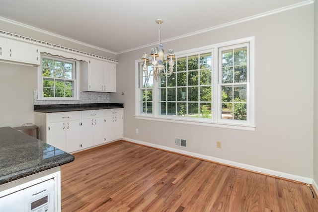 3134 Walton Way, Augusta, GA 30909 - kitchen featuring a chandelier, dark countertops, ornamental molding, baseboards, and light wood finished floors