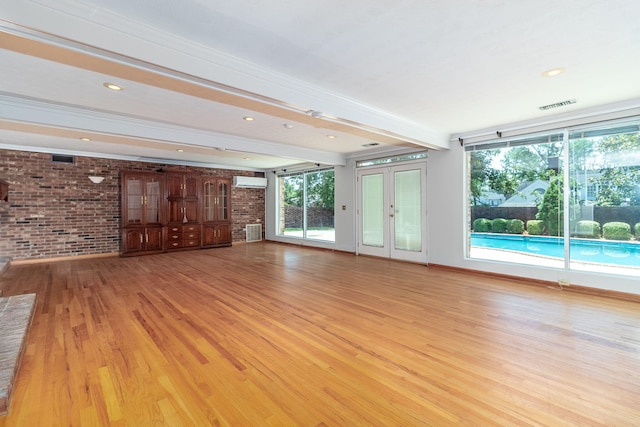 3134 Walton Way, Augusta, GA 30909 - unfurnished living room featuring brick wall, a wall mounted air conditioner, light wood-style flooring, recessed lighting, and beam ceiling