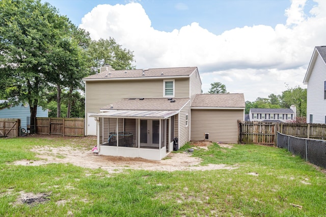 4375 Sandy Ridge Pl, Augusta, GA 30909 - back of house with a sunroom, a chimney, a fenced backyard, and a shingled roof