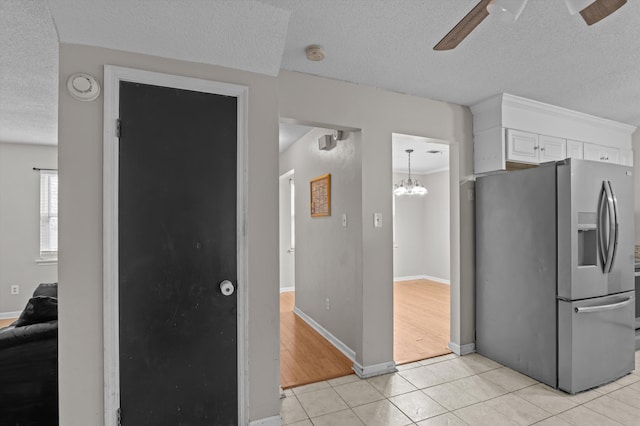 4375 Sandy Ridge Pl, Augusta, GA 30909 - kitchen with stainless steel refrigerator with ice dispenser, a ceiling fan, a textured ceiling, light tile patterned floors, and white cabinets