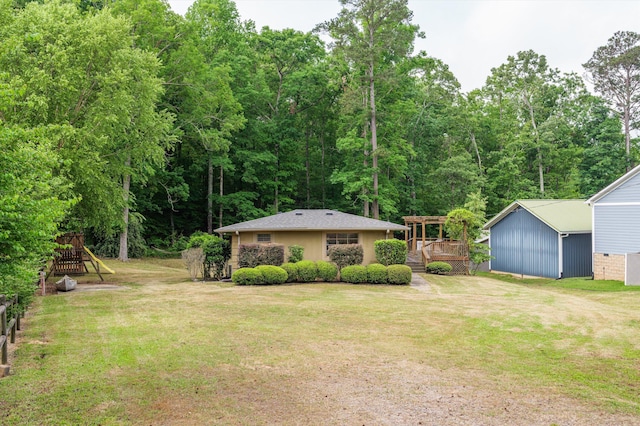 view of yard featuring an outbuilding and a wooden deck