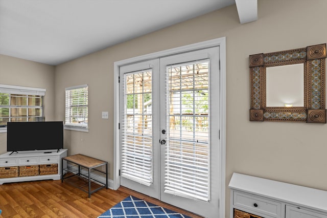 entryway with baseboards, french doors, and light wood-type flooring