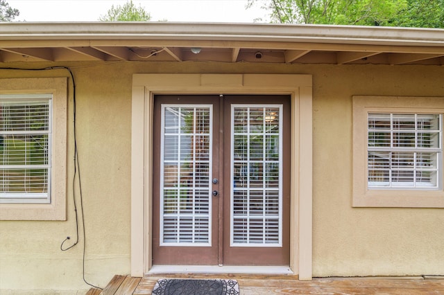 entrance to property with french doors and stucco siding