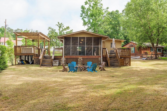 back of property with a pergola, a sunroom, a deck, stairway, and a fire pit