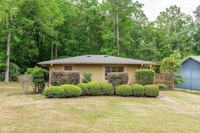 view of side of home with a lawn and stucco siding