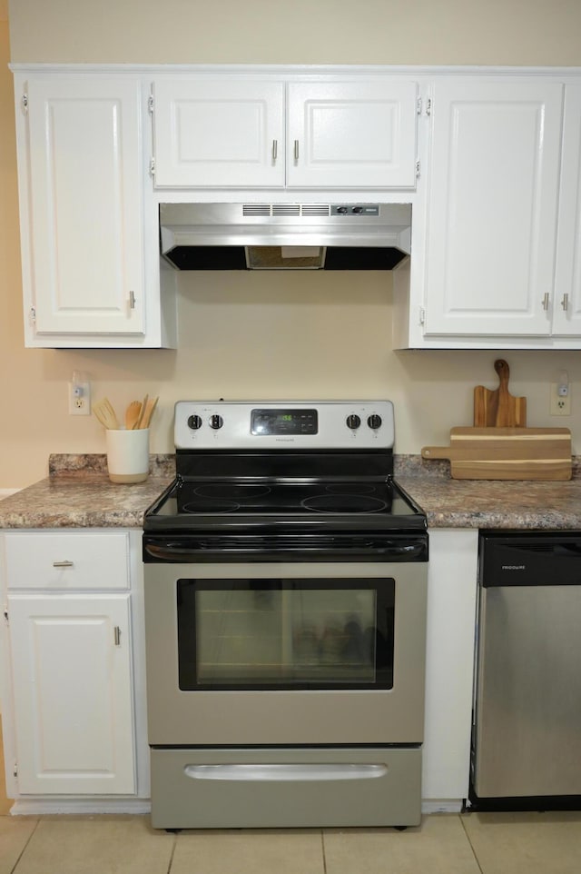 kitchen with ventilation hood, white cabinets, and stainless steel appliances