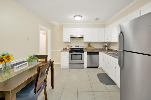 kitchen with white cabinets, light tile patterned floors, and stainless steel appliances