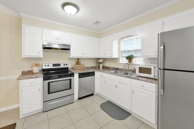 kitchen with sink, light tile patterned floors, a textured ceiling, appliances with stainless steel finishes, and white cabinetry