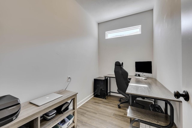 office area with baseboards and light wood-style floors