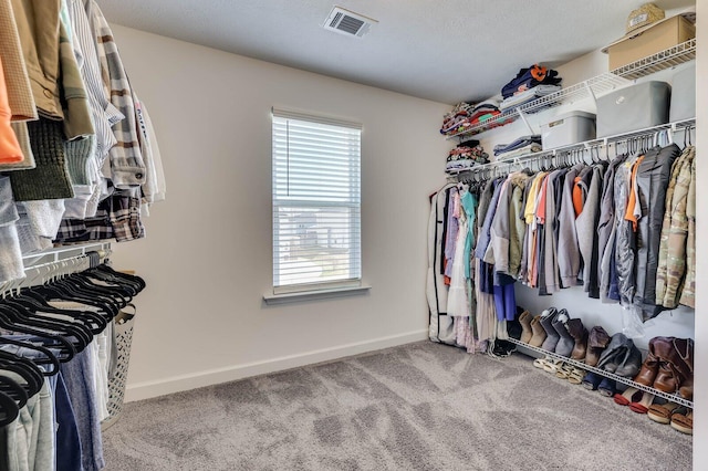 walk in closet featuring carpet flooring and visible vents