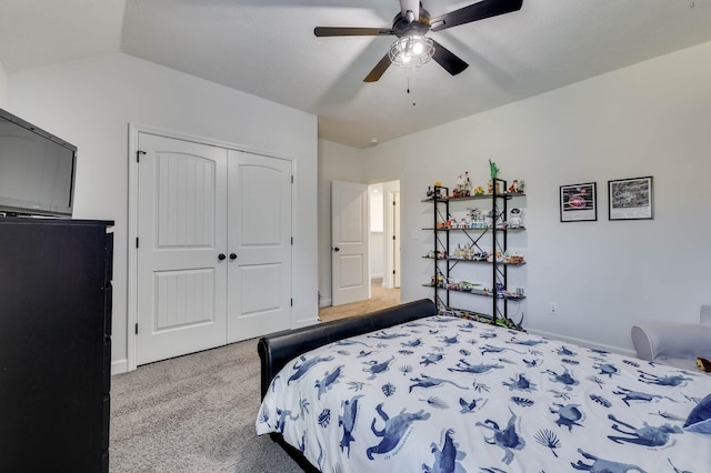 bedroom featuring baseboards, lofted ceiling, carpet flooring, a closet, and a ceiling fan