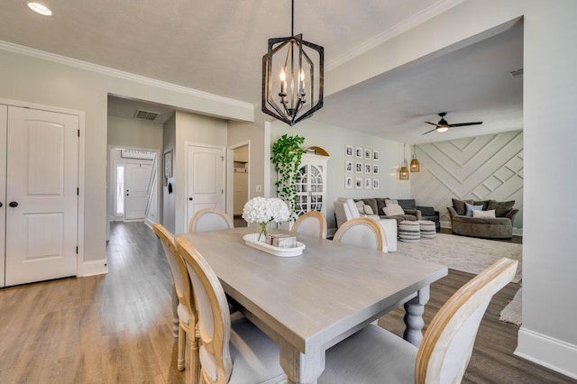 dining area with visible vents, baseboards, and wood finished floors