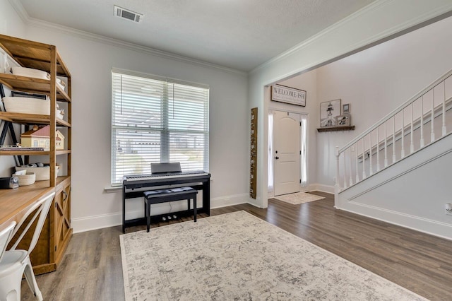 foyer featuring visible vents, crown molding, baseboards, dark wood-type flooring, and stairs