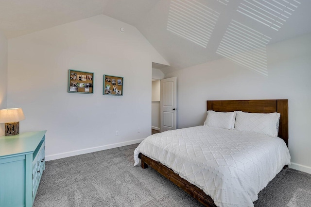 carpeted bedroom featuring baseboards and vaulted ceiling