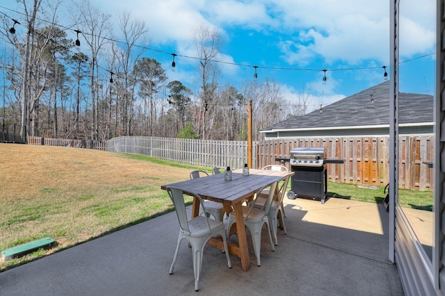 view of patio with outdoor dining space, area for grilling, and a fenced backyard