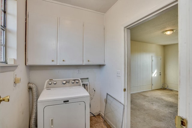 washroom featuring washer / clothes dryer, light carpet, cabinets, and a textured ceiling