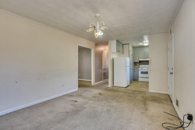 unfurnished living room with light carpet, ornamental molding, and a notable chandelier