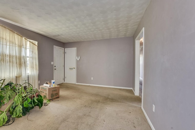 interior space featuring carpet flooring and a textured ceiling