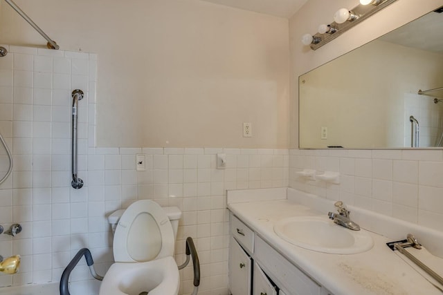 bathroom with toilet, vanity, tile walls, and walk in shower