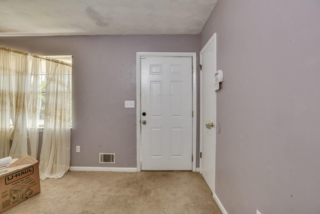 entrance foyer featuring light carpet