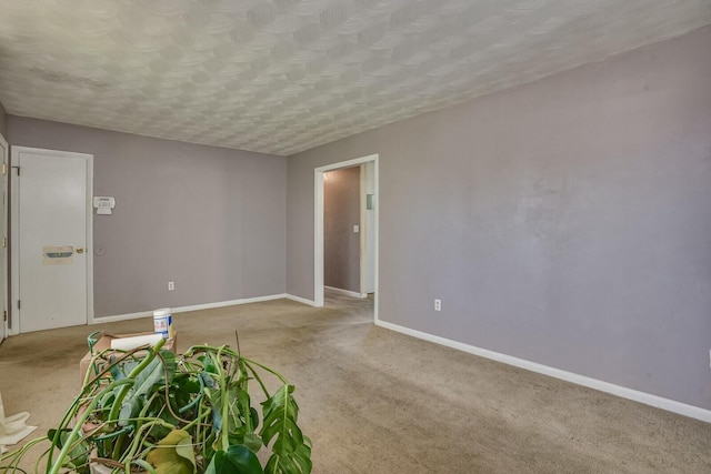 unfurnished room featuring light colored carpet and a textured ceiling