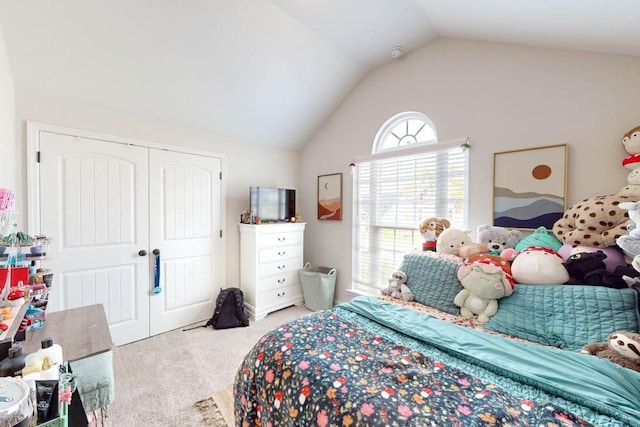 bedroom with a closet, carpet floors, and vaulted ceiling