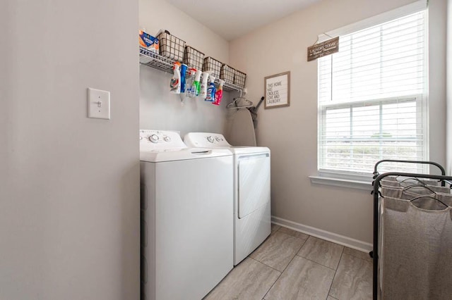 laundry room with baseboards, laundry area, and washer and dryer
