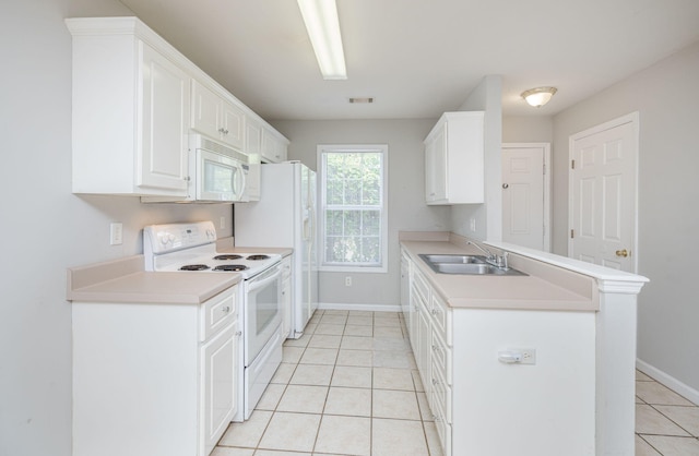5034 Wheeler Lake Rd, Augusta, GA 30909 - kitchen with white appliances, a sink, light tile patterned floors, a peninsula, and baseboards