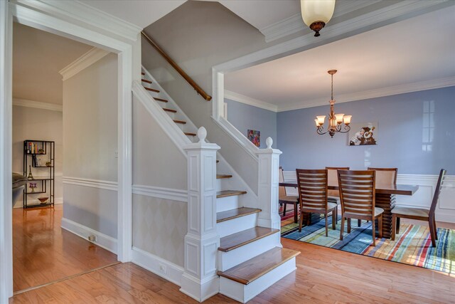 3463 Rhodes Hill Dr, Augusta, GA 30907 - stairs with wood finished floors, a chandelier, and ornamental molding