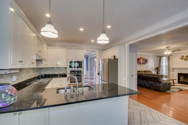 3463 Rhodes Hill Dr, Augusta, GA 30907 - kitchen with appliances with stainless steel finishes, a sink, ornamental molding, under cabinet range hood, and open floor plan