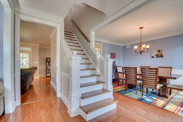 3463 Rhodes Hill Dr, Augusta, GA 30907 - dining area with stairs, light wood-style floors, a chandelier, and crown molding