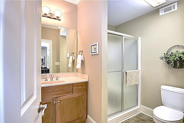 bathroom with vanity, toilet, an enclosed shower, and tile patterned flooring