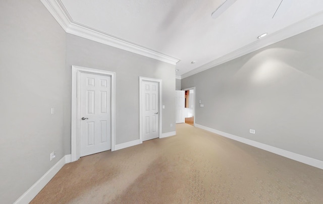 interior space featuring crown molding and carpet