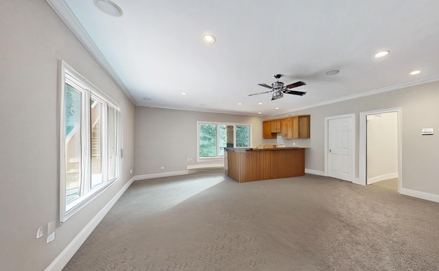 unfurnished living room featuring crown molding, light colored carpet, and ceiling fan