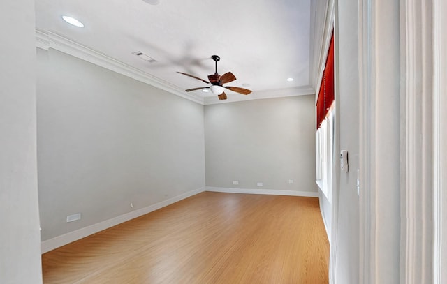 empty room with ornamental molding, light hardwood / wood-style floors, and ceiling fan