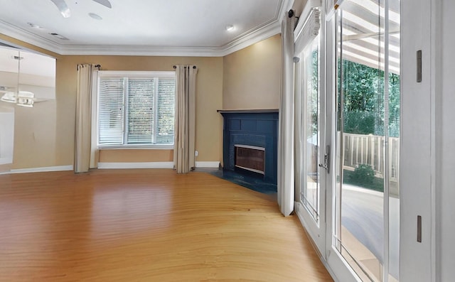 unfurnished living room featuring crown molding and light hardwood / wood-style flooring