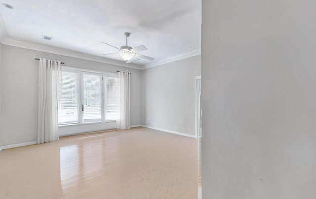 unfurnished room featuring ceiling fan and ornamental molding