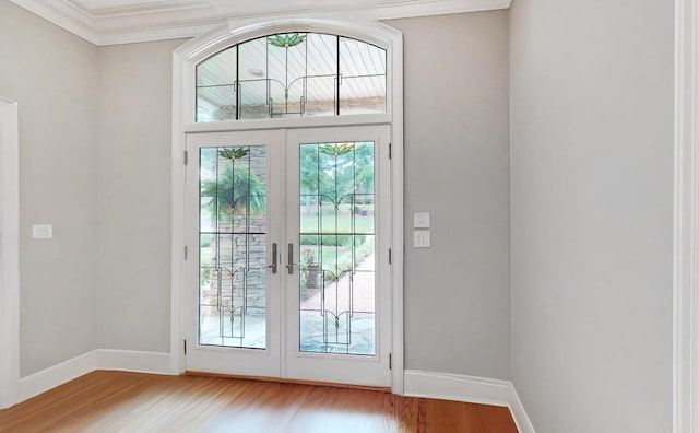 doorway to outside with ornamental molding, hardwood / wood-style floors, and french doors