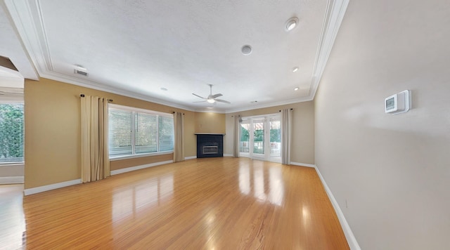 unfurnished living room featuring crown molding, light hardwood / wood-style floors, and ceiling fan