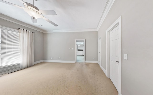 empty room with ceiling fan, a healthy amount of sunlight, and light carpet